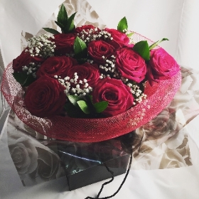 12 red roses in bag